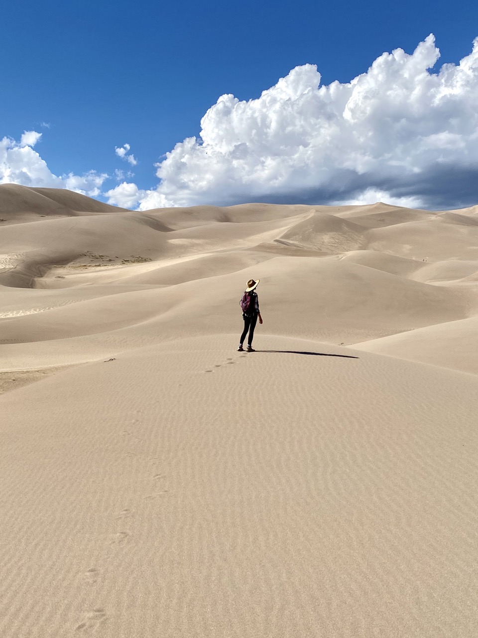 The Most Underrated National Park - The Great Sand Dunes. caroline with background of the dunes