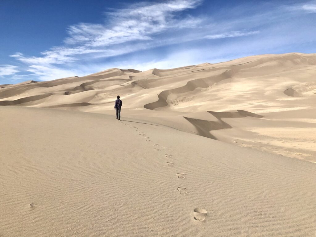 jonathan walking on the great sand dunes