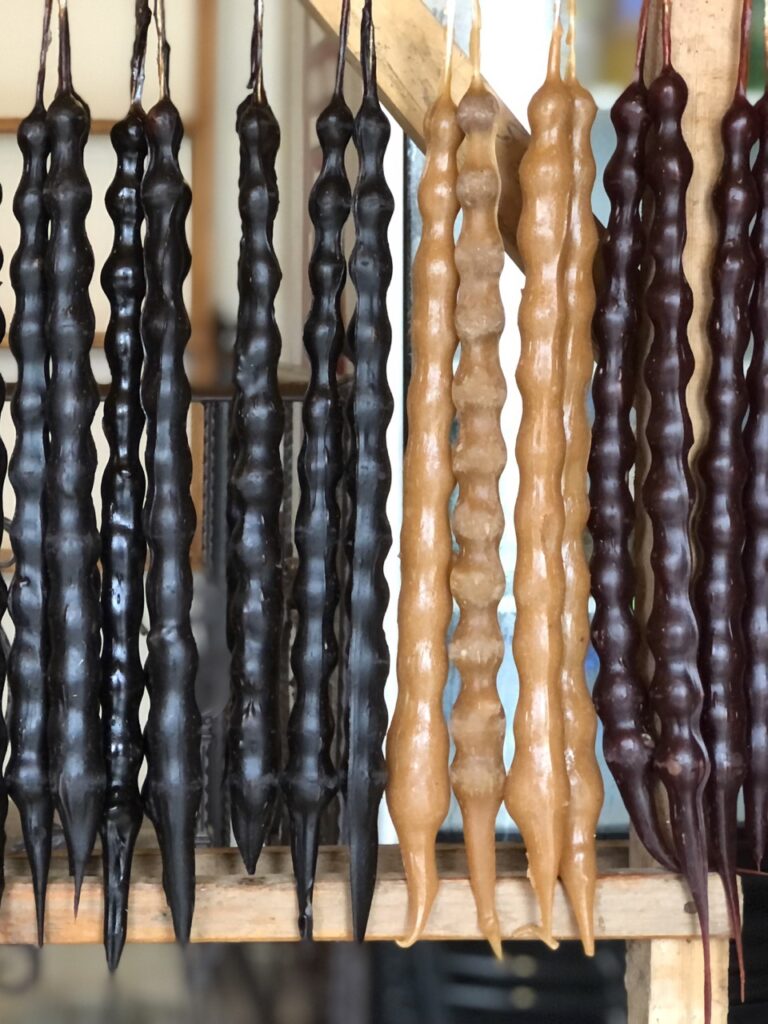 black, brown and tan strands of Churchkhela, a local georgian dessert. 10 awesome things to do in tbilisi, georgia.