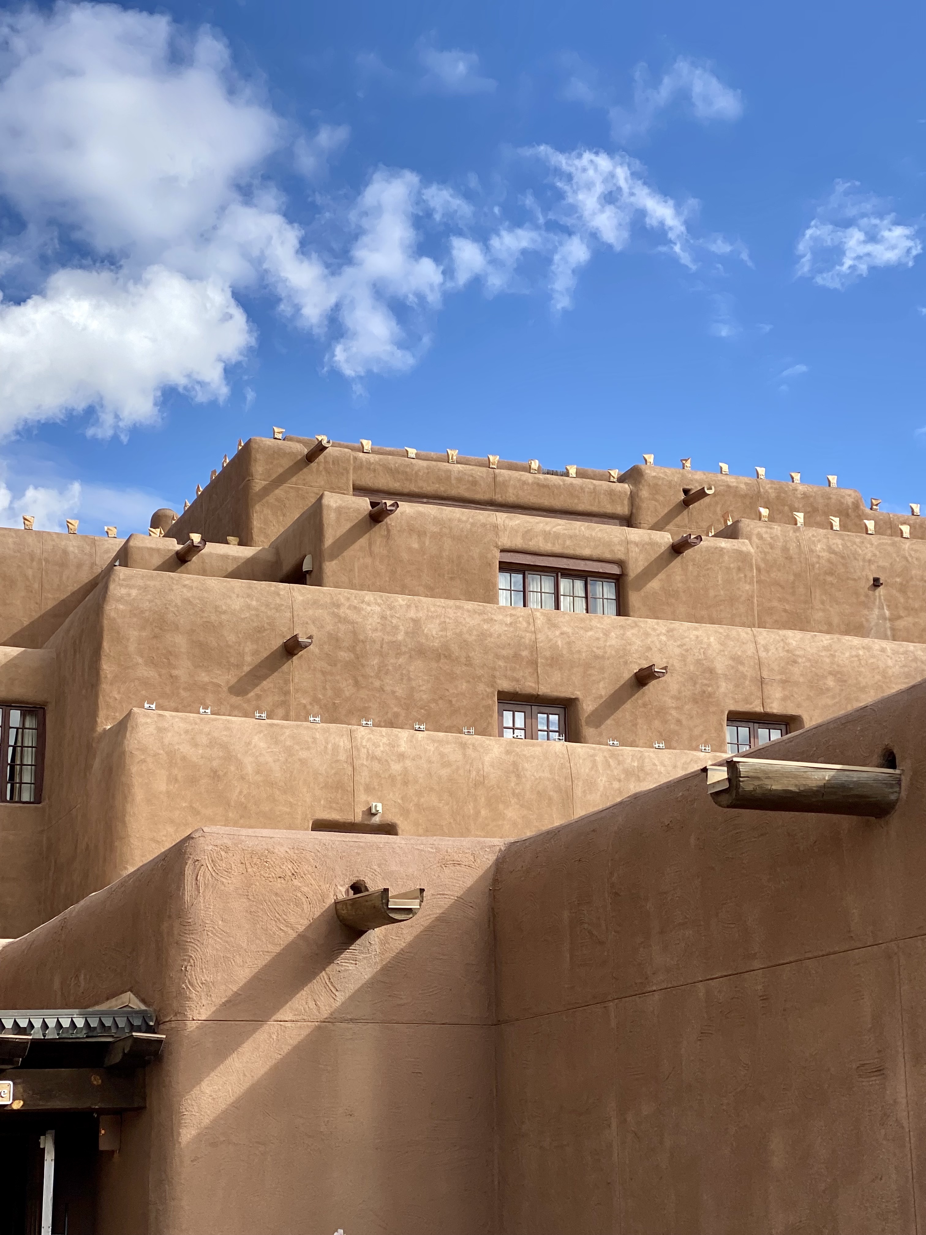 the best outdoor activities around santa fe. blue sky backdrop and brown building. 