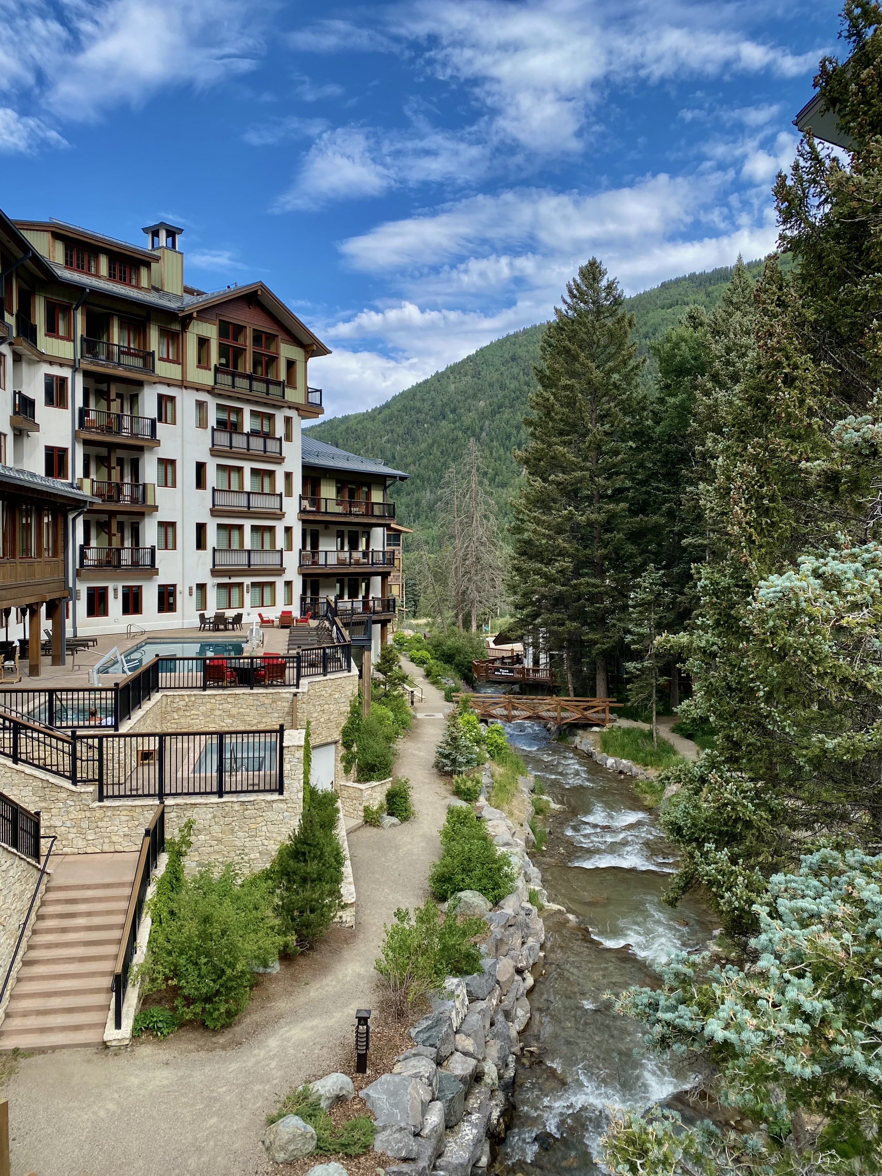 lodge style hotel with river and pine tree setting