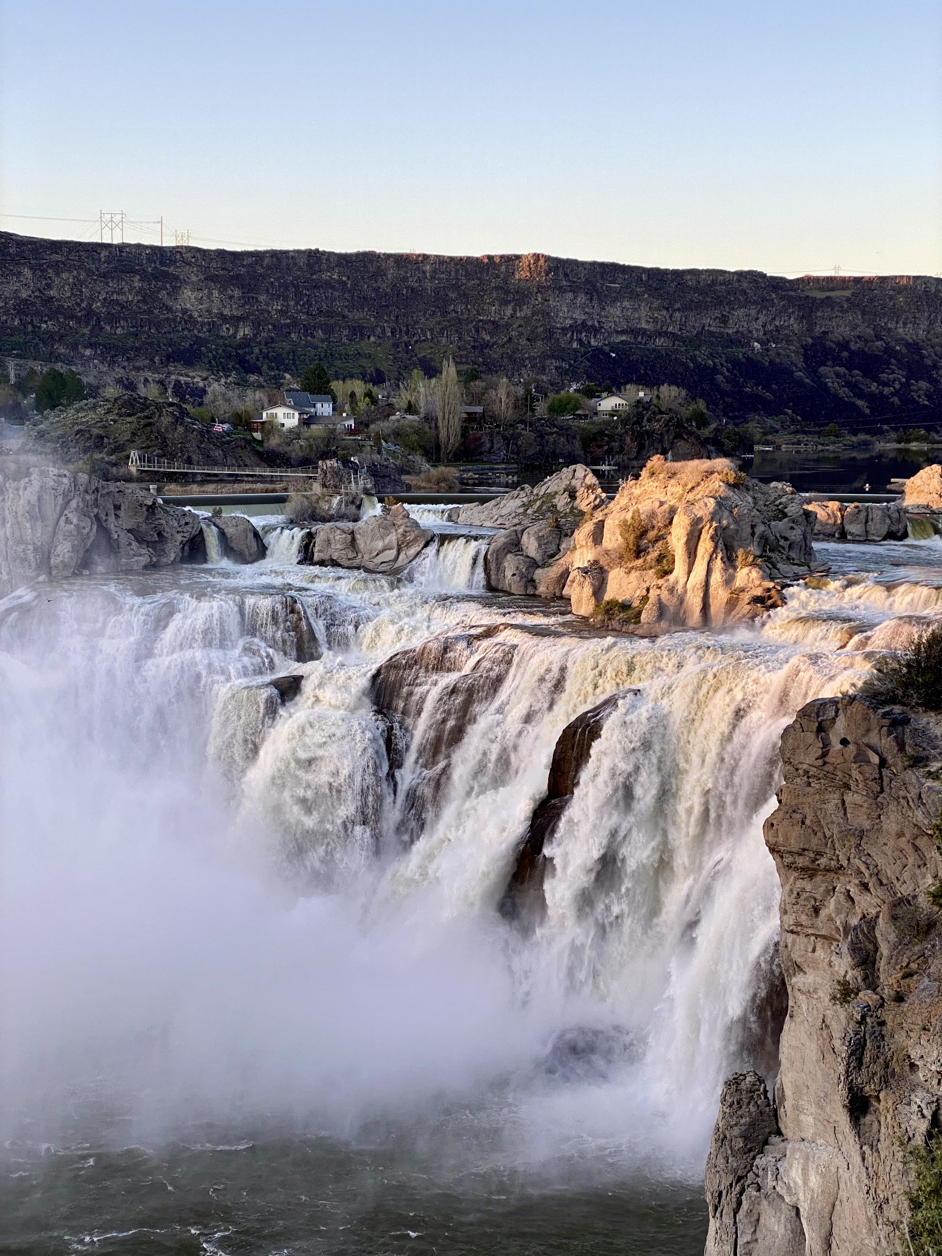 large flowing waterfall at sunset. 